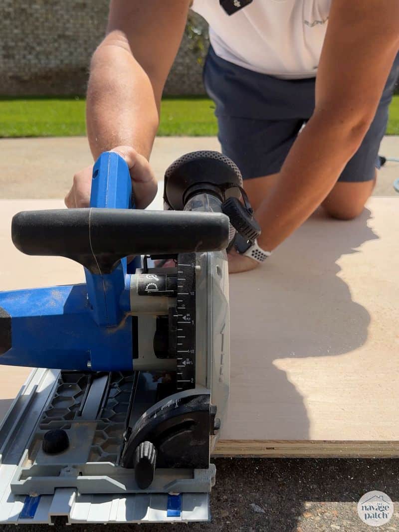man cutting plywood