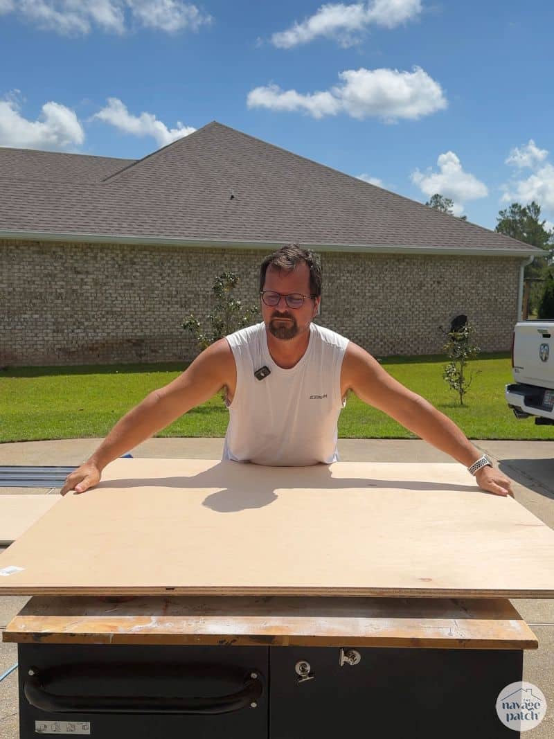 man cutting a circle in plywood