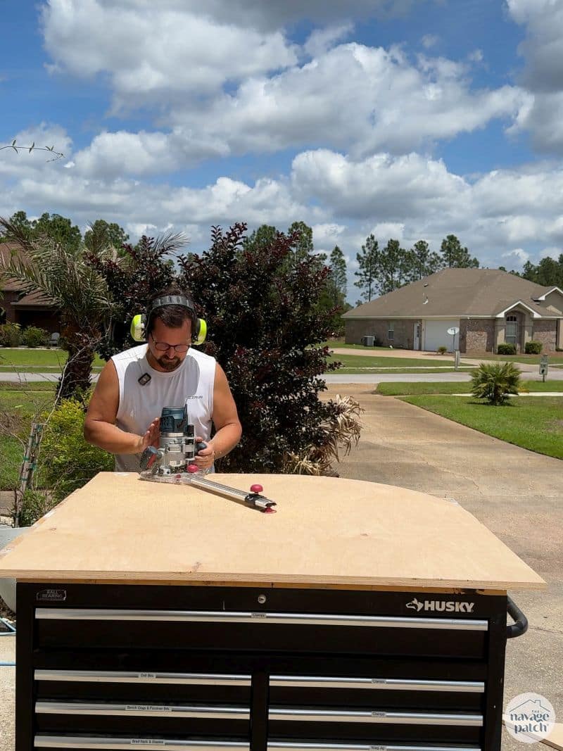 man cutting a circle in plywood