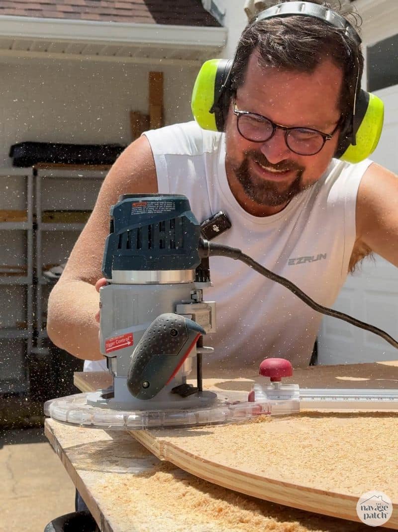 man cutting a circle in plywood