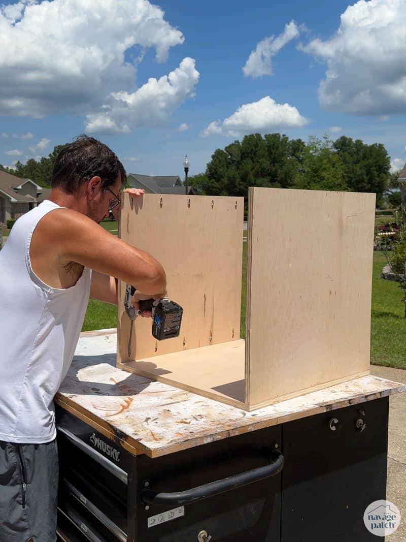 man building a cabinet box