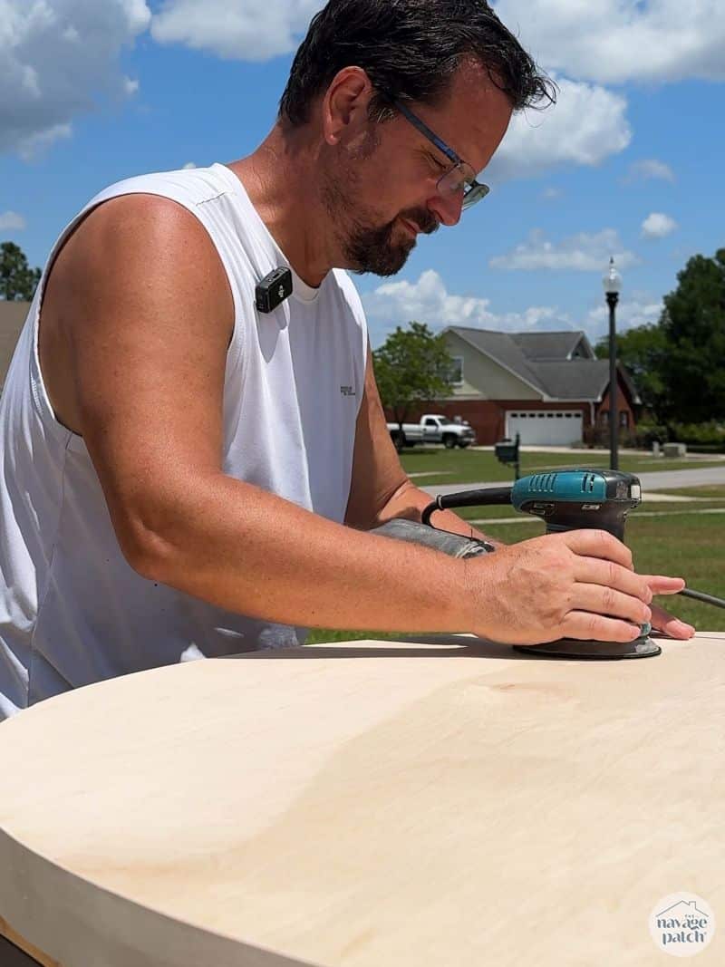 man sanding a tabletop