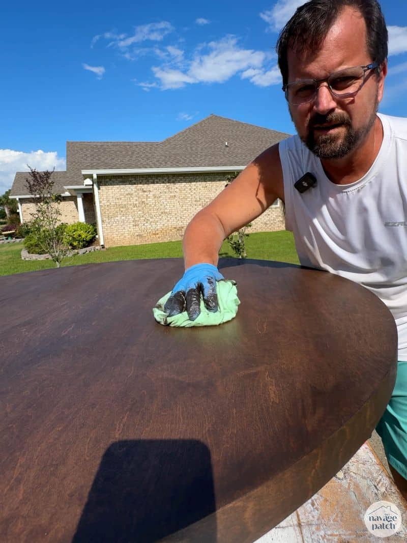 man staining a cabinet