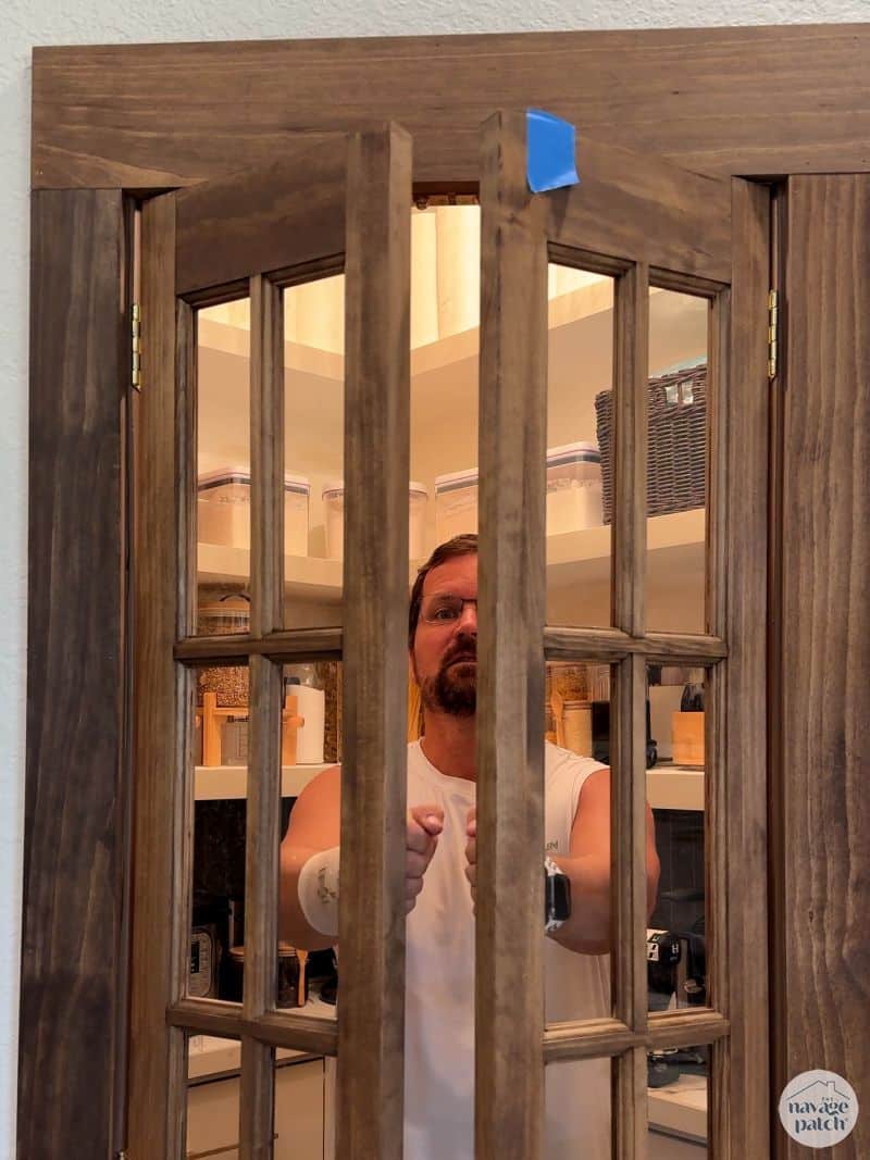 man installing french doors to a pantry