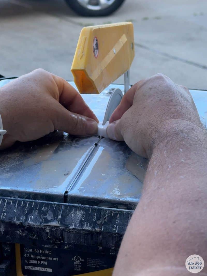 man cutting tile