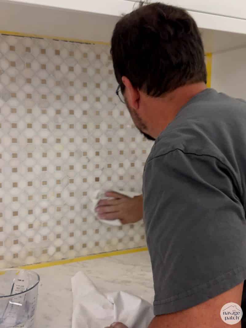man removing grout haze