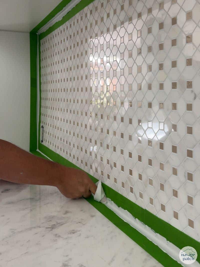 caulking a tiled wall