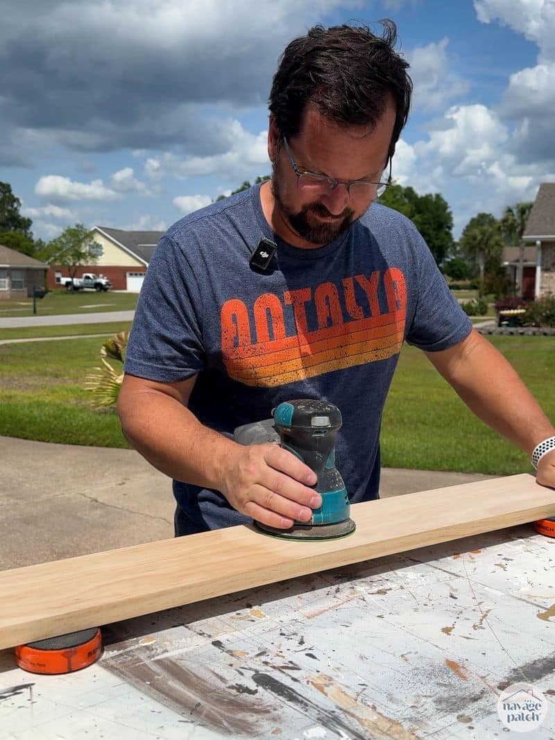 man sanding a board