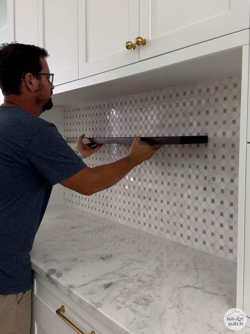 man hanging shelf 