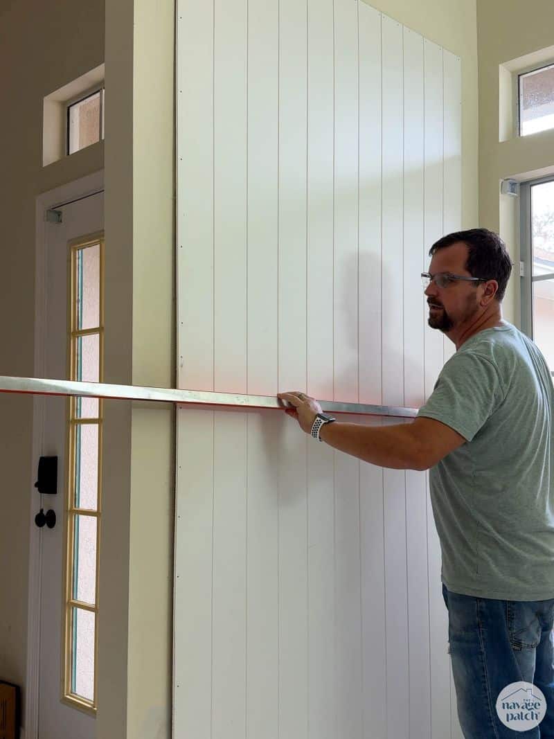 man checking a wall's level