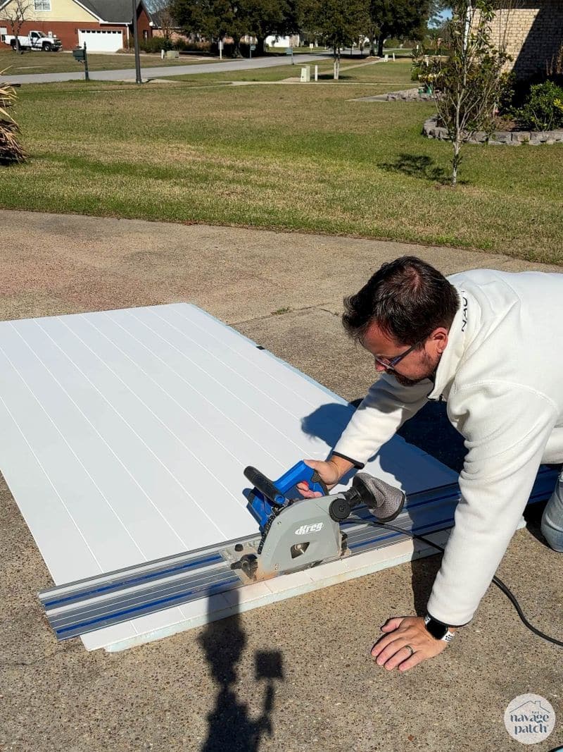 man cutting a shiplap panel