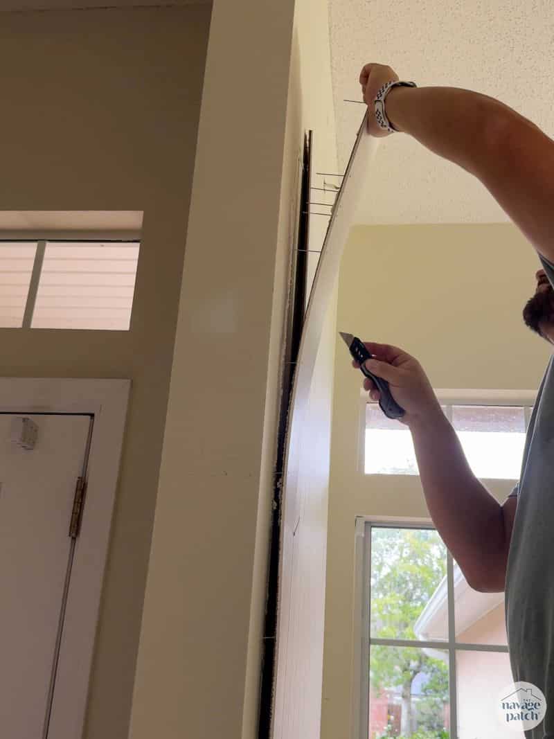 man removing part of a wall panel
