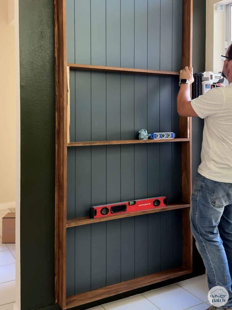 man adding shelves to a plate rack