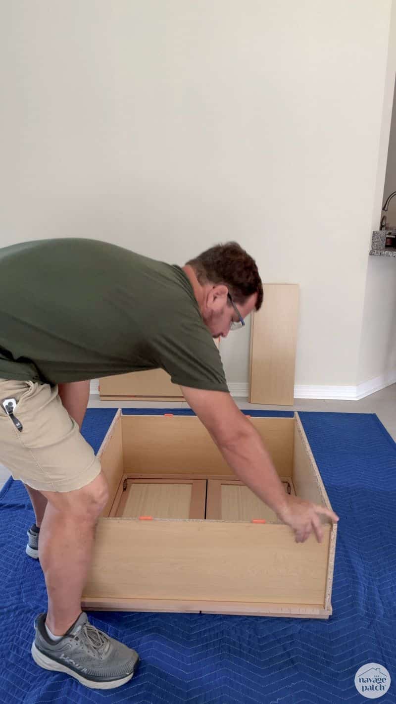 man building an RTA cabinet
