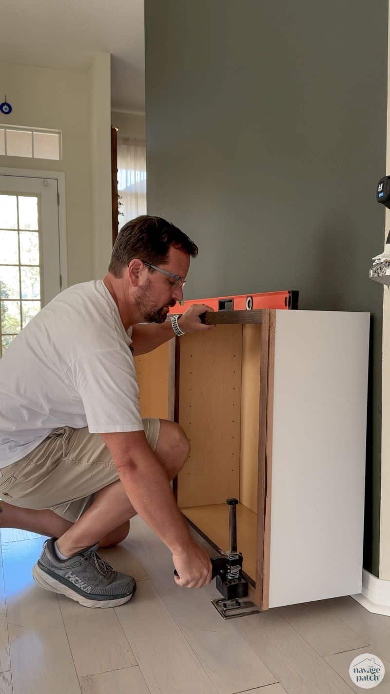 man lifting cabinets off the floor