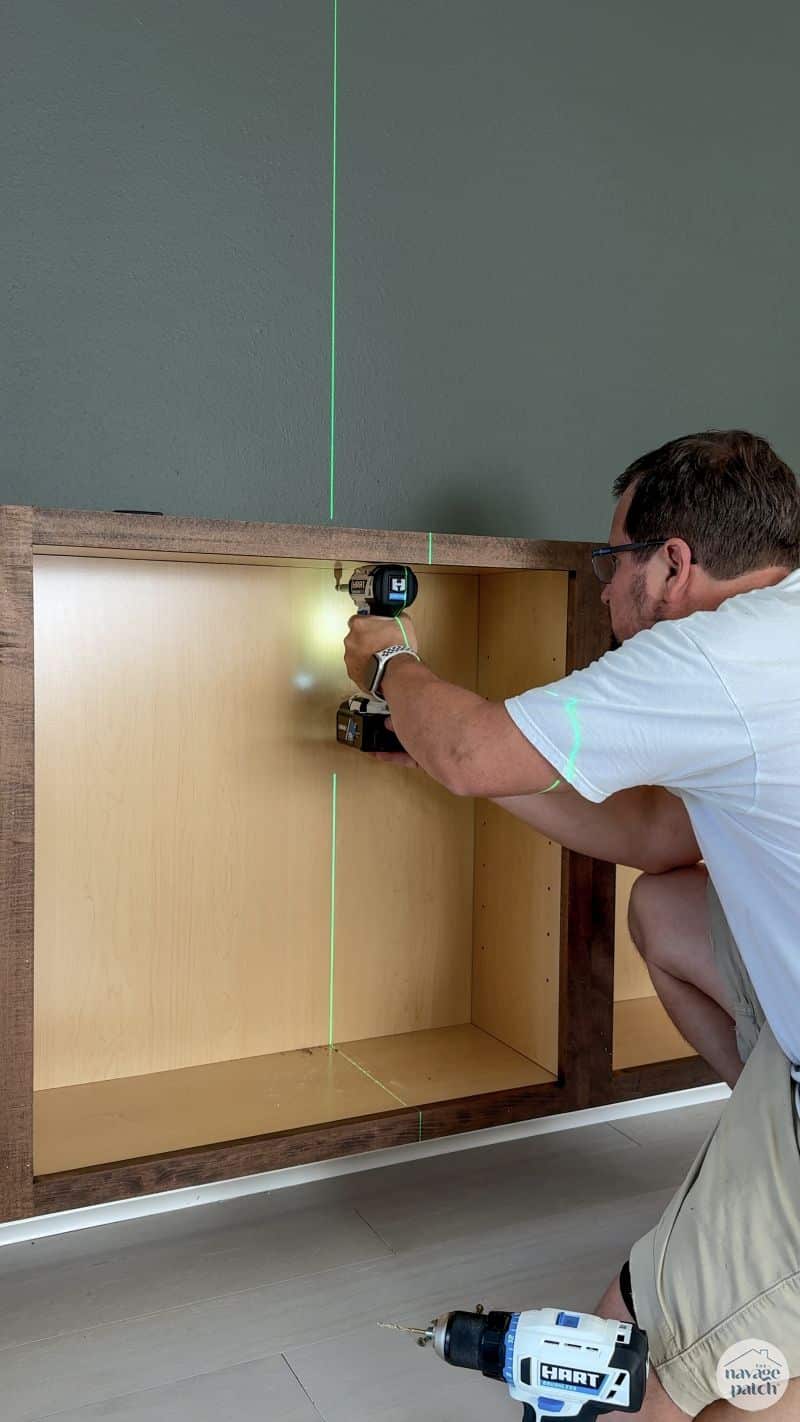man hanging cabinets