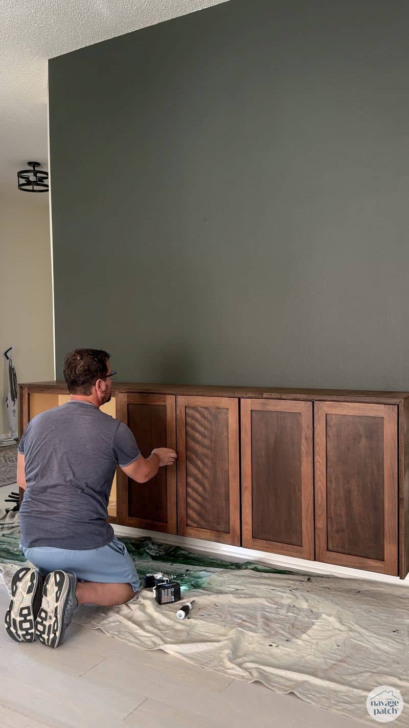 man attaching doors to cabinets