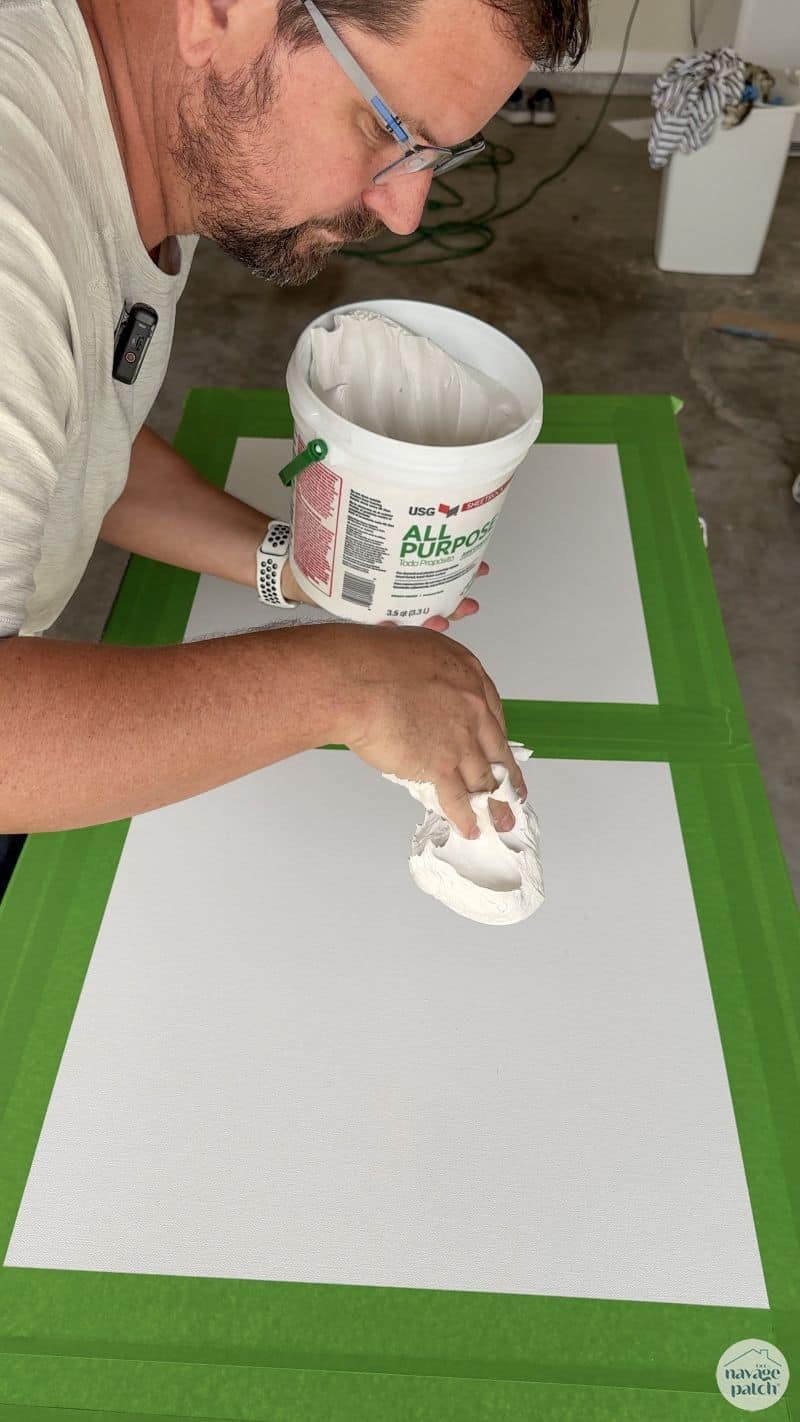 man making art with joint compound