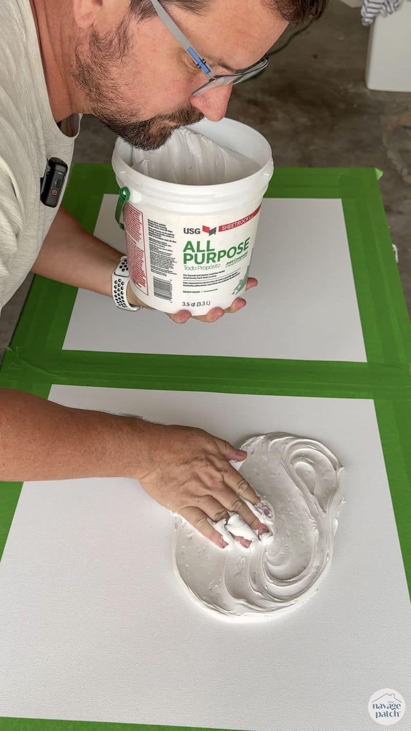 man making art with joint compound