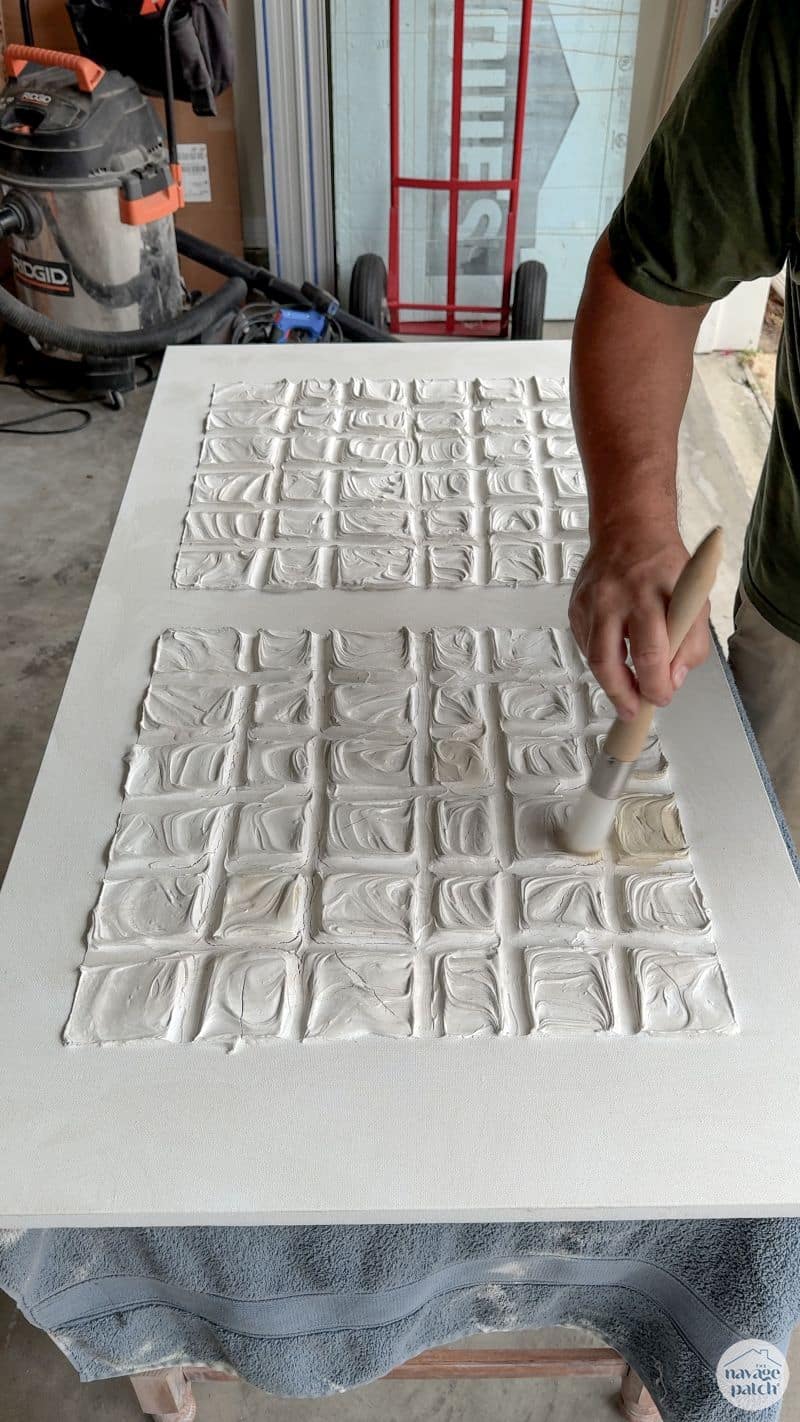 man making art with joint compound