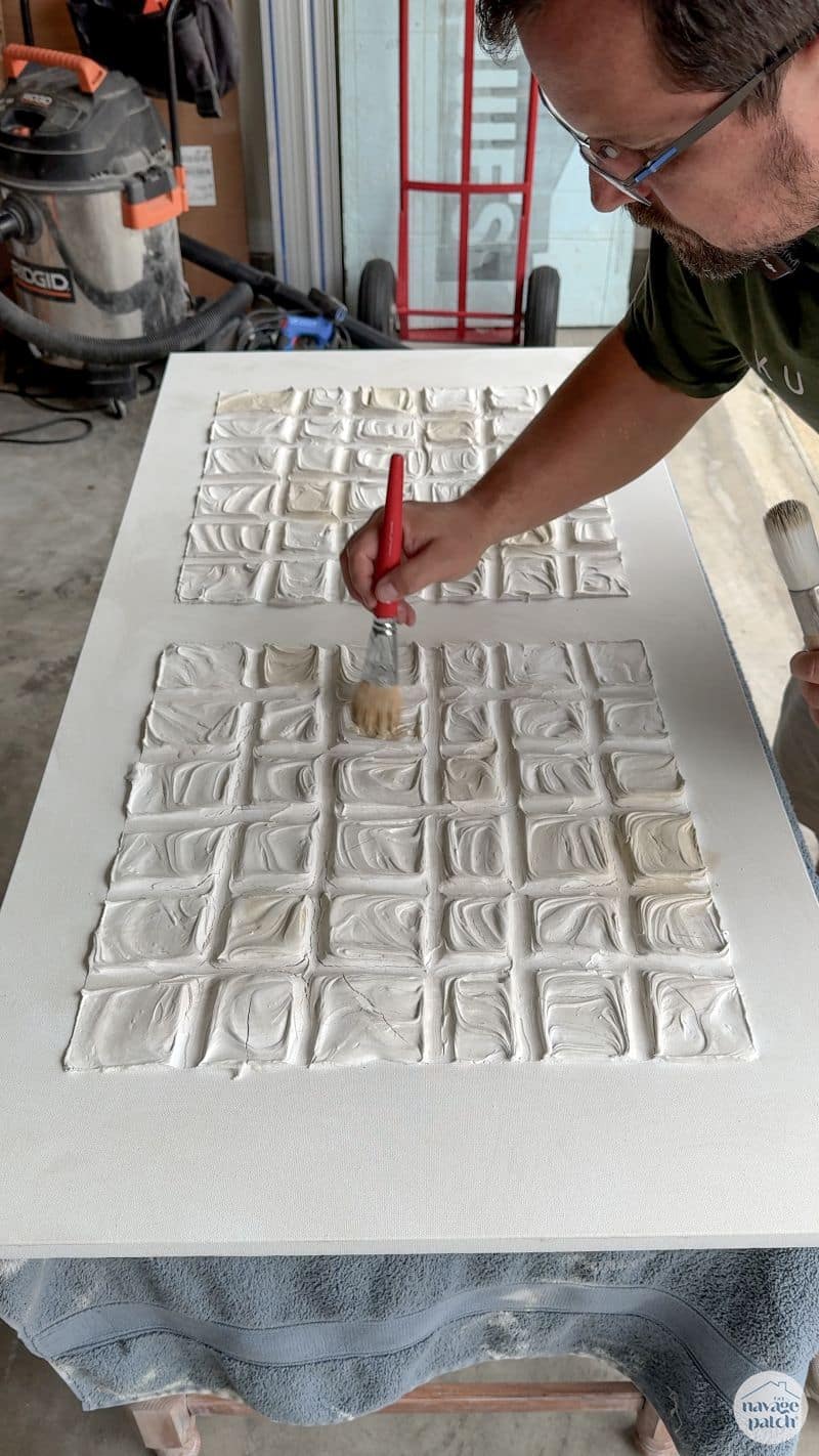 man making art with joint compound