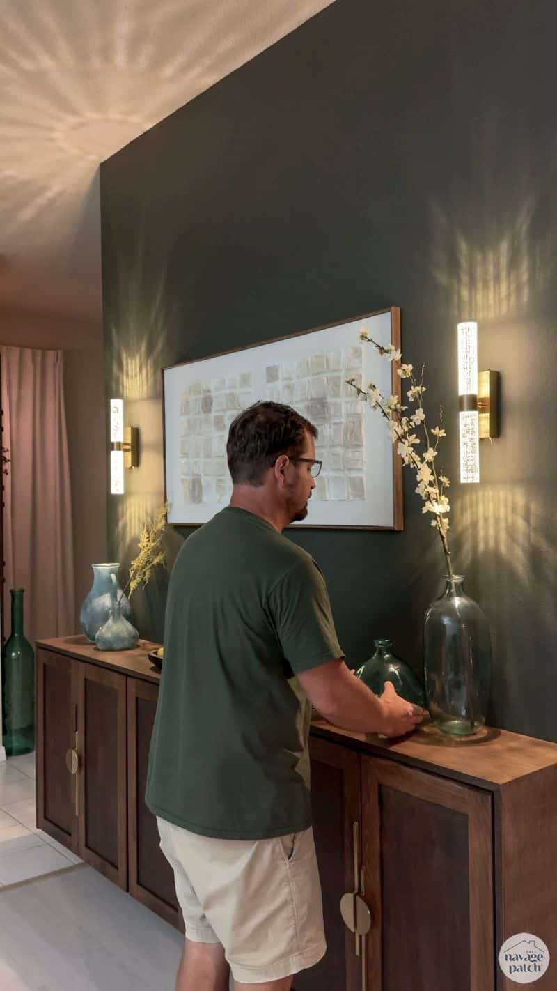 man styling a floating console table